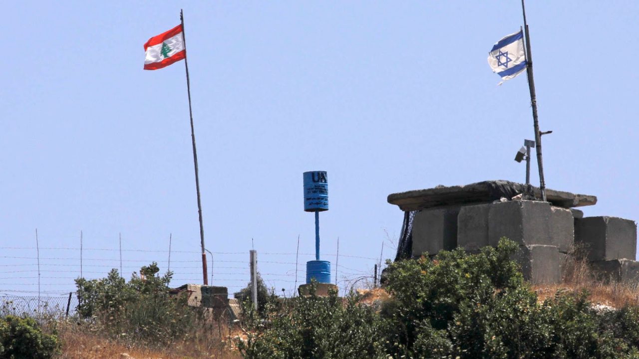 A picture taken on July 12, 2020 near the northern Israeli town of Shtula shows the "blue line" sign, a demarcation line drawn by the UN to mark Israel's withdrawal from southern Lebanon in 2000, near the Lebanese village of Aita al-Shaab. (Photo by JALAA MAREY / AFP)