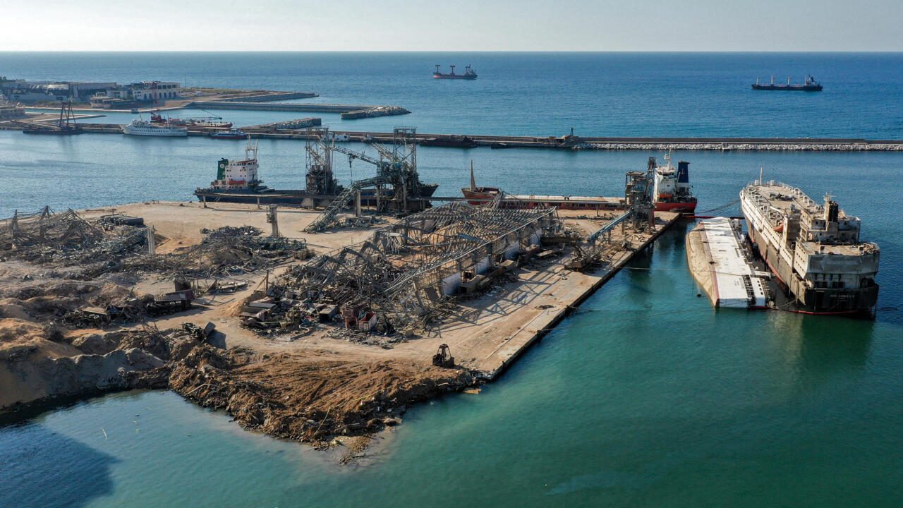 This picture taken on August 21, 2020 shows an aerial view of the flattened warehouse at the port of Lebanon's capital Beirut next to the crater left by the explosion at the other warehouse that housed a huge cache of ammonium nitrate and which ravaged the city in early August. (Photo by - / AFP)