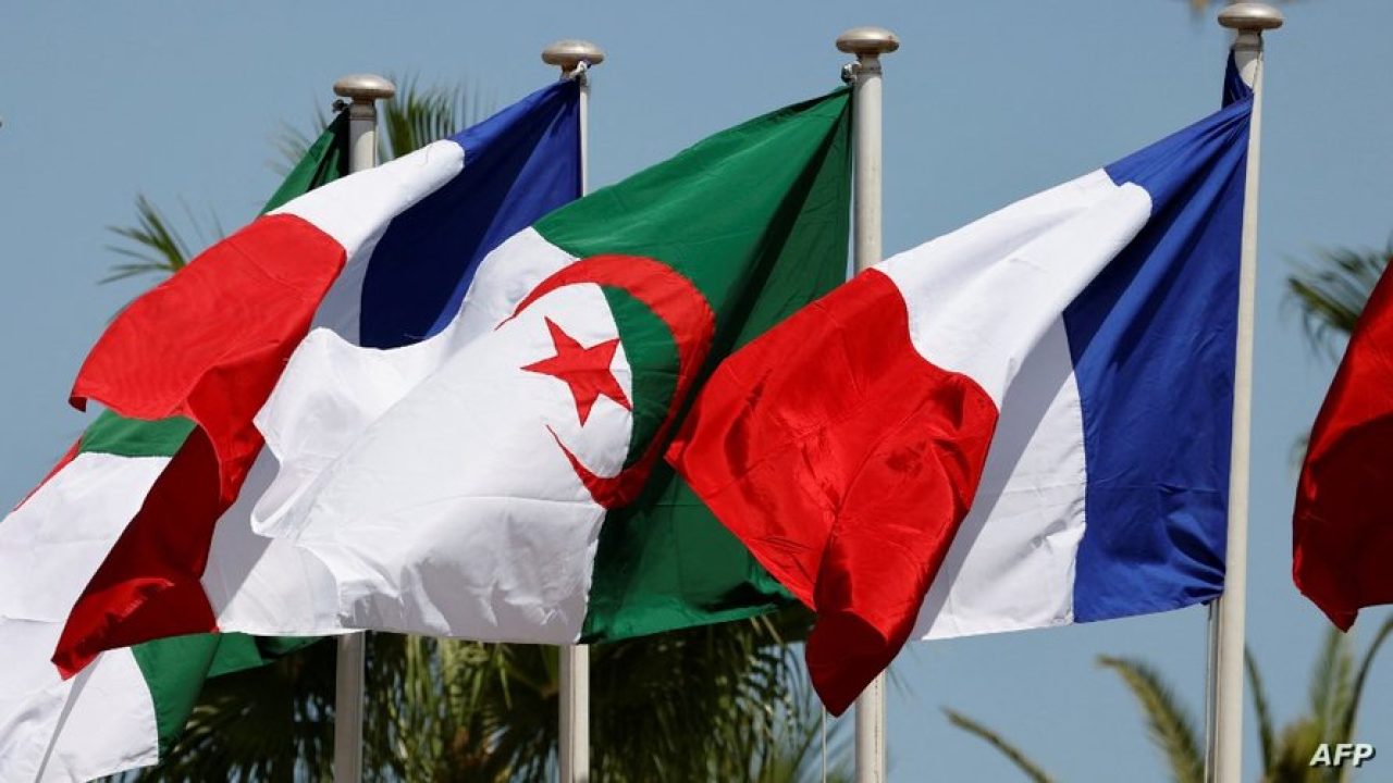 This picture taken on August 25, 2022 shows French and Algerian flags ahead of the arrival of the French president in Algiers for an official visit. The French president starts a three-day visit to Algeria on August 25, to help mend ties with the former French colony, which this year marks its 60th anniversary of independence. (Photo by Ludovic MARIN / AFP)