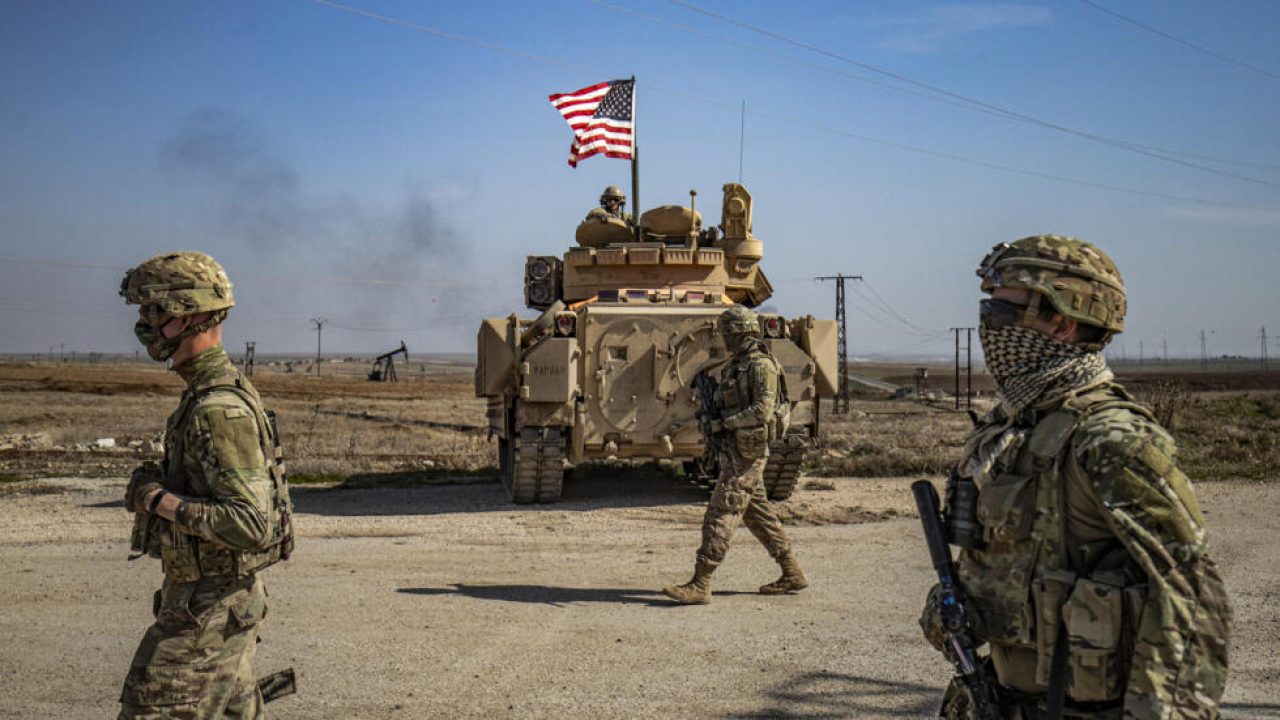 US soldiers walk while on patrol by the Suwaydiyah oil fields in Syria's northeastern Hasakah province on February 13, 2021. (Photo by Delil SOULEIMAN / AFP)