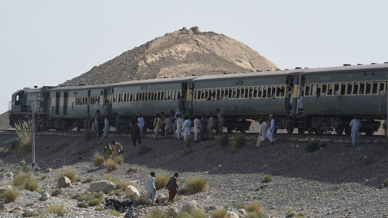 Pakistani passengers gather around a train following two explosions in the town of Much, 55 kilometres east of Balochistan's provincial capital Quetta, on October 7, 2016. Two explosions targeting military personnel on a passenger train killed at least six people and wounded 19 others in Pakistan's troubled southwestern Balochistan province on October 7, officials said. The attack, claimed by the separatist Baloch Liberation Army, came as the Rawalpindi-bound Jaffer Express was passing the town of Much, 55 kilometres east of Balochistan's provincial capital Quetta. (Photo by BANARAS KHAN / AFP)