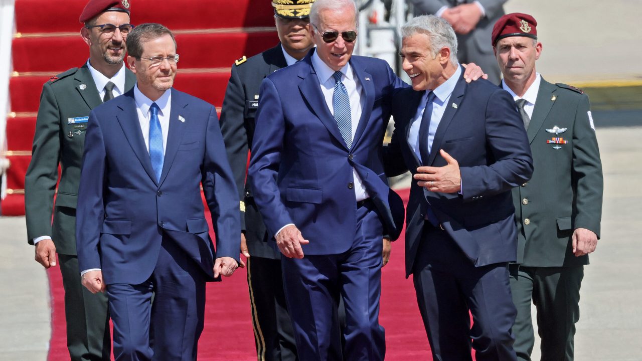 ISRAEL-US-DIPLOMACY US President Joe Biden (C) is welcomed by Israeli President Isaac Herzog (L) and caretaker Prime Minister Yair Lapid upon his arrival at Ben Gurion Airport in Lod near Tel Aviv, on July 13, 2022. (Photo by JACK GUEZ / AFP) (Photo by JACK GUEZ/AFP via Getty Images)