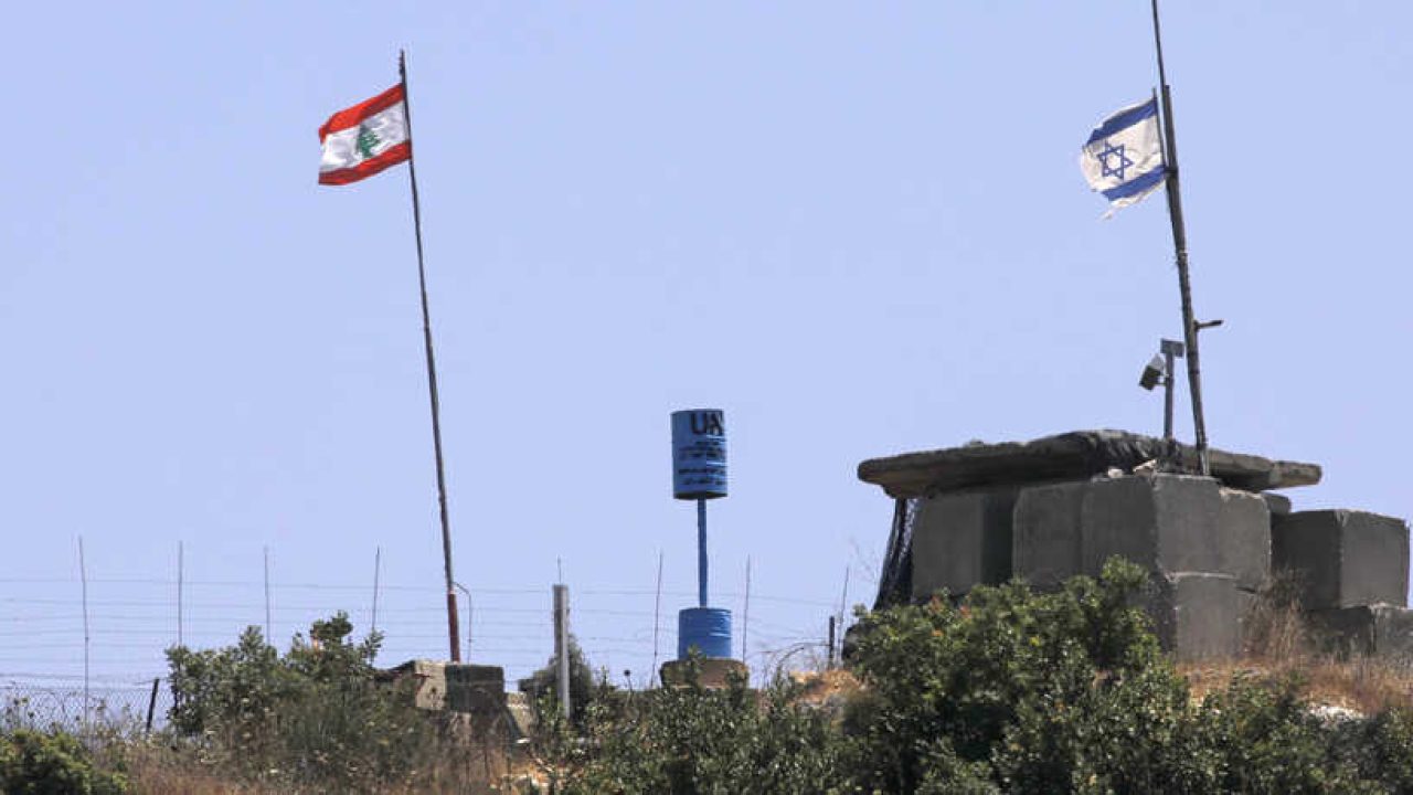 ISRAEL-LEBANON-CONFLICT A picture taken on July 12, 2020 near the northern Israeli town of Shtula shows the "blue line" sign, a demarcation line drawn by the UN to mark Israel's withdrawal from southern Lebanon in 2000, near the Lebanese village of Aita al-Shaab. (Photo by JALAA MAREY / AFP)