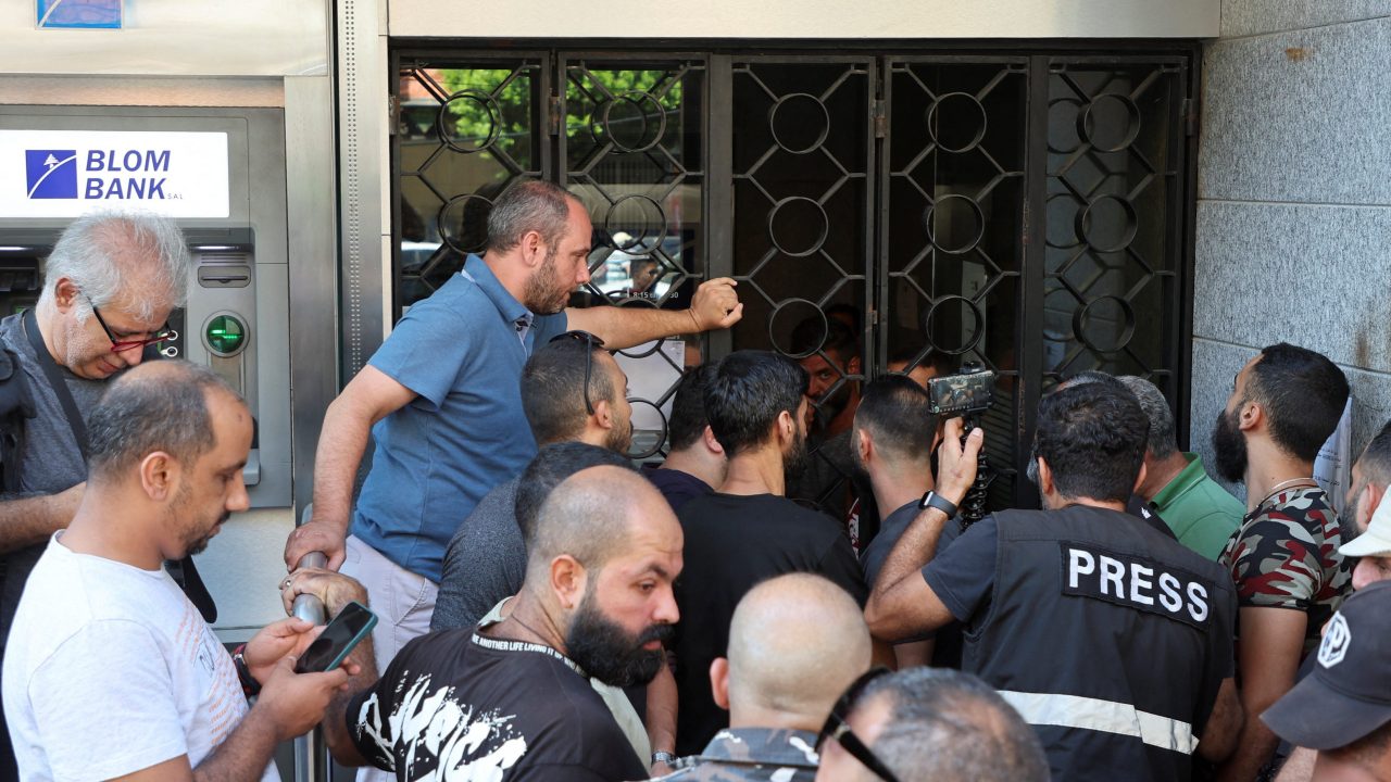 People stand outside a Blom Bank branch in the Lebanese capital's Tariq al-Jdideh neighborhood People stand outside a Blom Bank branch in the Tariq al-Jdideh neighborhood in Beirut, Lebanon September 16, 2022. REUTERS/Mohamed Azakir