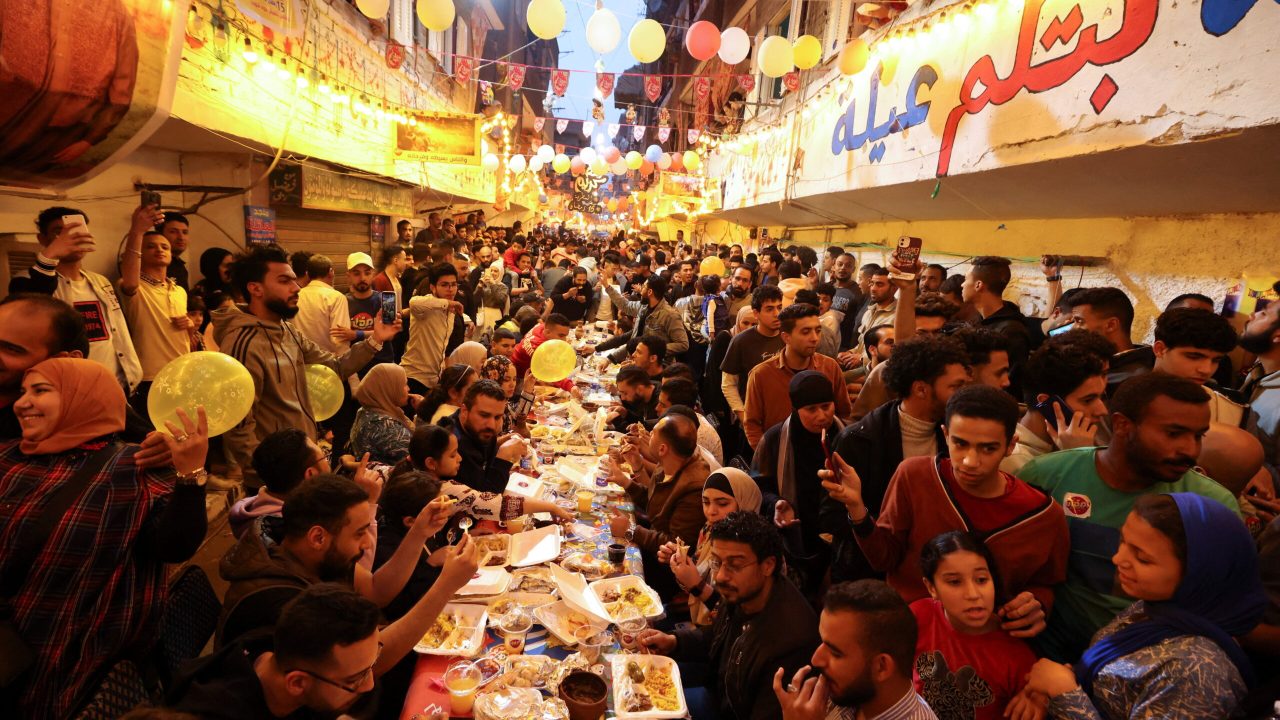 Residents of Ezbet Hamada in Cairo's Mataria district gather to eat Iftar, the meal to end their fast at sunset, during the holy fasting month of Ramadan in Cairo, Egypt April 6, 2023. REUTERS/Mohamed Abd El Ghany