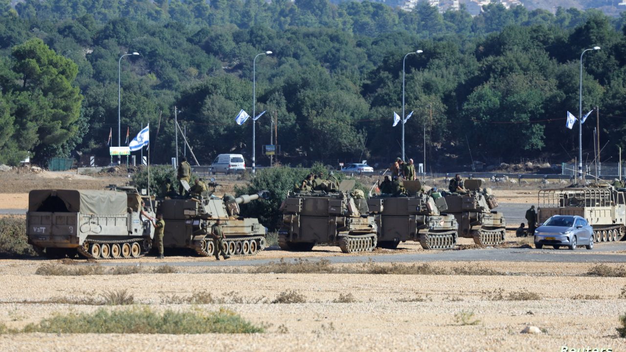 Soldiers stand on military vehicles, near the border with Lebanon, in northern Israel, November 8, 2023. REUTERS/Alexander Ermochenko