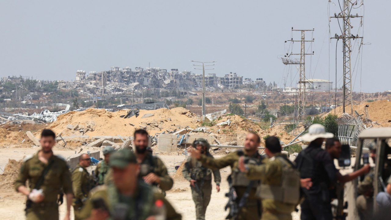 Israeli soldiers walk through an area of the Gaza Strip, amid the ongoing conflict in Gaza between Israel and the Palestinian Islamist group Hamas, near the Erez Crossing point in northern Gaza, May 1, 2024. REUTERS/Ronen Zvulun