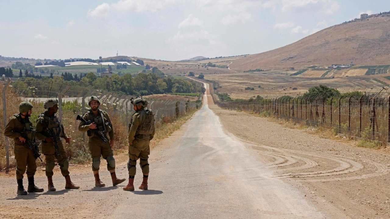 Israeli soldiers stand guard during ongoing maintenance work along the Lebanese border, near Avivim town in northern Israel on June 13, 2023. (Photo by JALAA MAREY / AFP)