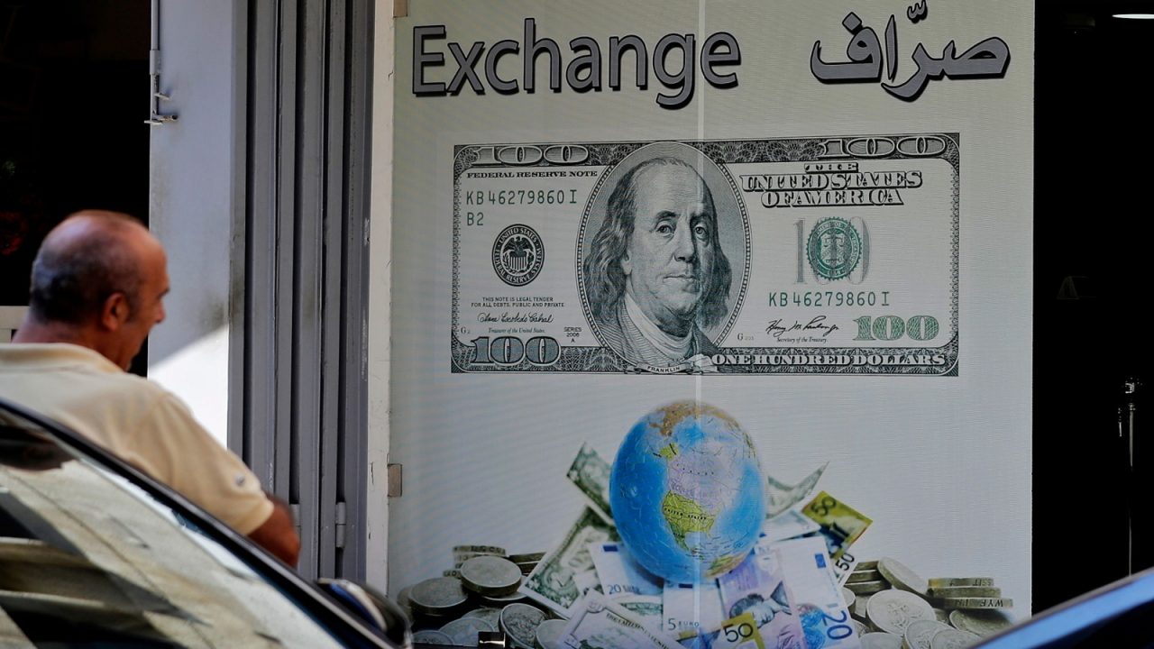 LEBANON-POLITICS-ECONOMY A man stands outside a currency exchange company in the Lebanese capital Beirut on October 1, 2019. - Lebanon's central bank announced Monday adopting a measure to facilitate access to US dollars for importers of petroleum products, wheat, and medicine, state media said Tuesday, following fears of a dollar shortage and possible currency devaluation, in a country which has had a fixed exchange rate of around 1,500 Lebanese pounds to the dollar in place since 1997. (Photo by JOSEPH EID / AFP) (Photo credit should read JOSEPH EID/AFP/Getty Images)