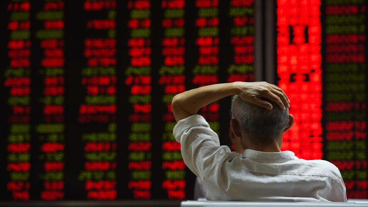 CHINA-ECONOMY-STOCKS An investor looks at screens showing stock market movements at a securities company in Beijing on July 14, 2015. Hundreds of firms were expected to resume trading again on July 14, adding to the more than 400 that returned July 13, after they were suspended over the past few weeks to prevent a market meltdown. Authorities intervened after the Shanghai index plunged 30 percent in three weeks, wiping trillions of dollars from market capitalisations, spreading contagion in regional markets and raising fears over the potential impact to the real economy. AFP PHOTO / GREG BAKER (Photo credit should read GREG BAKER/AFP/Getty Images)
