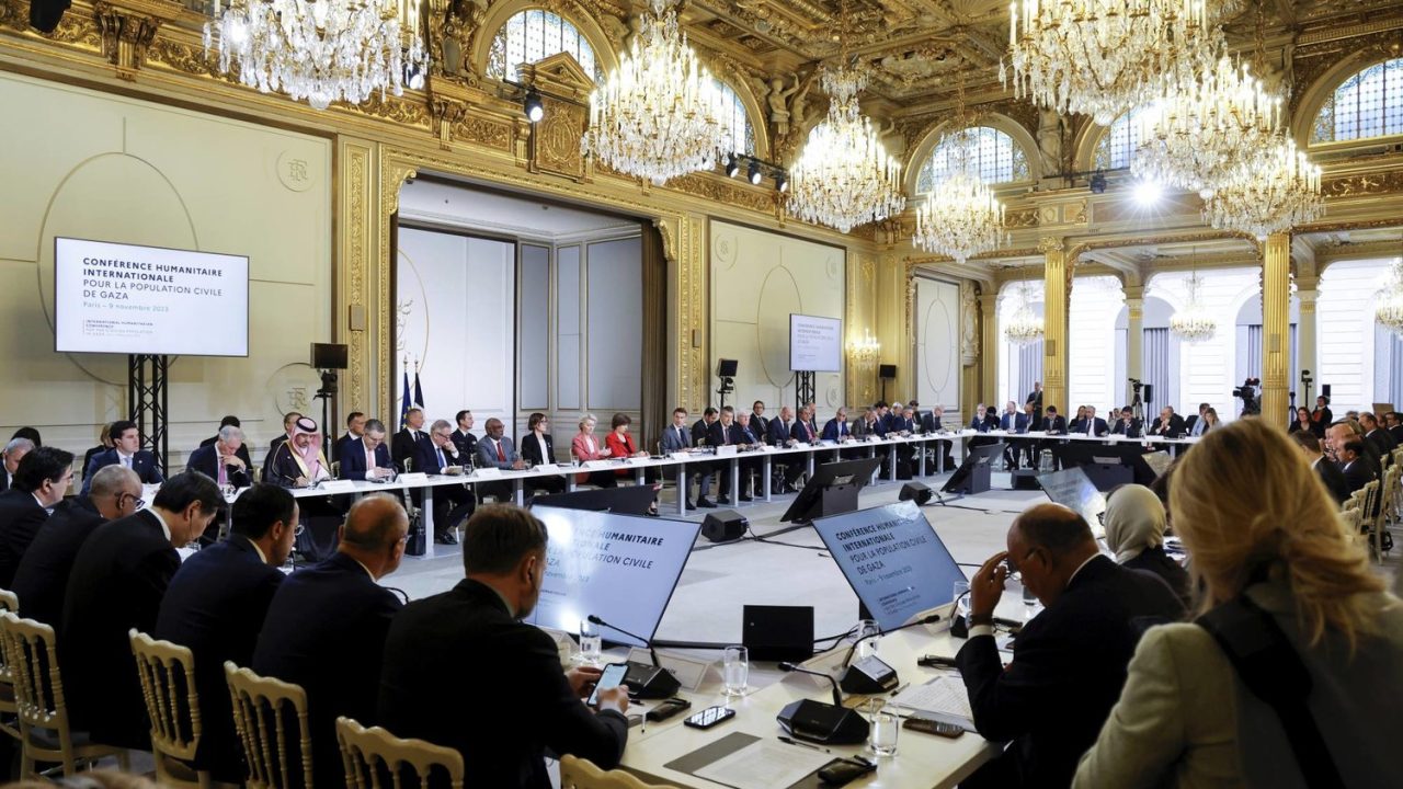 French President Emmanuel Macron, center, speaks during a meeting with officials from Western and Arab nations, the United Nations and nongovernmental organizations at the Elysee Palace, in Paris, Thursday, Nov. 9, 2023. Macron has opened a Gaza aid conference with an appeal for Israel to protect civilians, saying that "all lives have equal worth" and that fighting terrorism "can never be carried out without rules." (Ludovic Marin, Pool via AP)