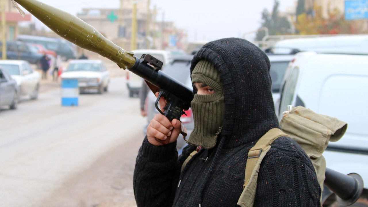 A Shiite gunman holds an rocket-propelled grenade as they block vehicles on a road in the village of Bazzaliyeh which leads the eastern Lebanese town of Arsal in the Bekaa valley, near the border with Syria, as they search for the killer of Lebanese policeman Ali al-Bazaal on December 6, 2014. The Al Qaeda-linked Syrian extremist group the Al-Nusra front claimed to have killed the captured Lebanese policeman to avenge the arrest of militants' wives and children. AFP PHOTO / STR        (Photo credit should read STR/AFP via Getty Images)