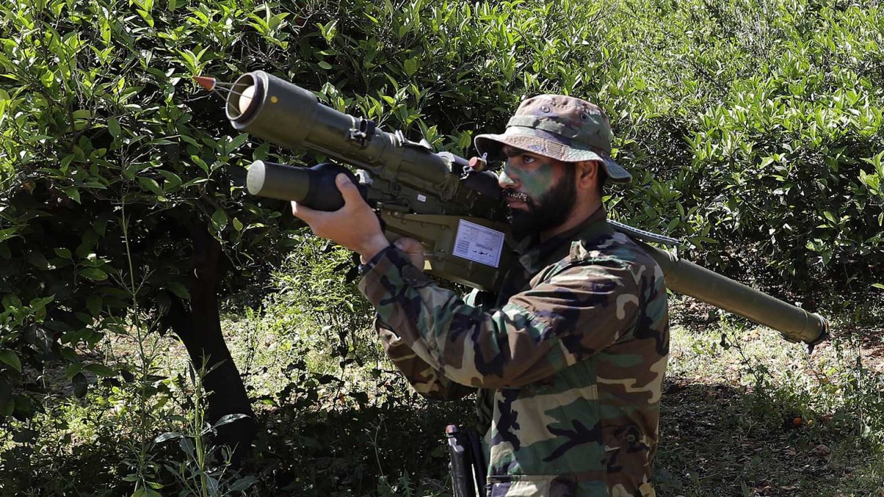 A Hezbollah fighter is seen standing at attention in an orange field near the town of Naqura on the Lebanese-Israeli border on April 20, 2017.
Lebanon's Hezbollah, which fought a devastating war with the Jewish state in 2006, brought dozens of journalists to the demarcation line between Lebanon and Israel, to show that Israel is building up defences in anticipation of another conflict. / AFP PHOTO / JOSEPH EID        (Photo credit should read JOSEPH EID/AFP/Getty Images)