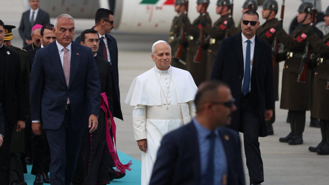 Pope Leo XIV, accompanied by Turkey's Culture and Tourism Minister Mehmet Nuri Ersoy, attends a welcoming ceremony as he arrives at Esenboga International Airport, during his first apostolic journey, in Ankara, Turkey, November 27, 2025. REUTERS/Cagla Gurdogan