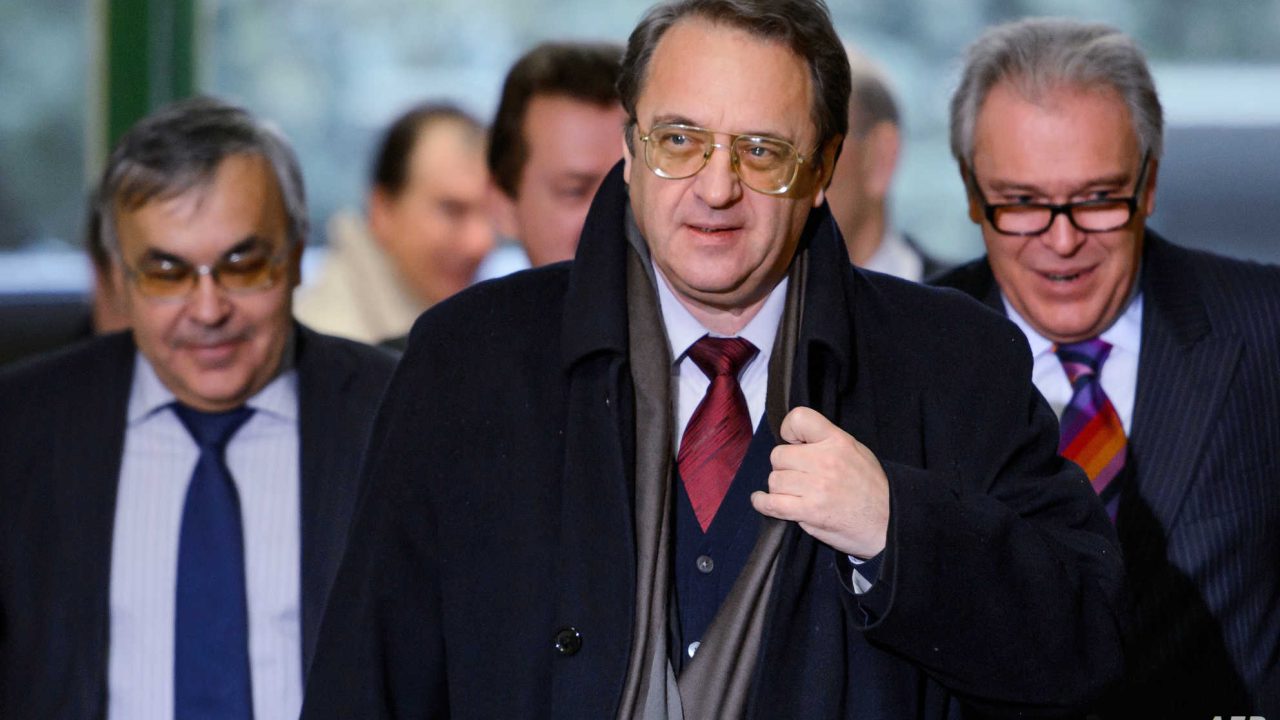 Russian deputy foreign minister Mikhail Bogdanov (C) arrives for a meeting on December 20, 2013 at the United Naitons offices in Geneva. UN-Arab League envoy Lakhdar Brahimi kicks off fresh talks with US and Russian negotiators as they seek to smooth the way to January peace talks between Syria's government and rebels.  AFP PHOTO / FABRICE COFFRINI