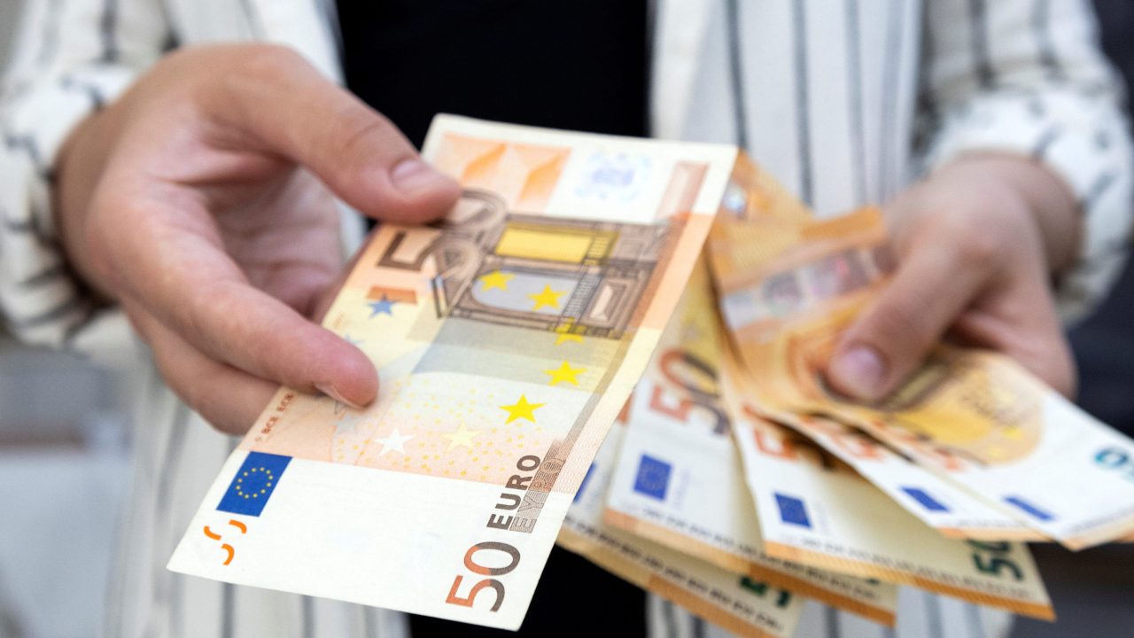 Illustration shows Euro banknotes FILE PHOTO: A woman holds Euro banknotes in this illustration taken May 30, 2022. REUTERS/Dado Ruvic/Illustration