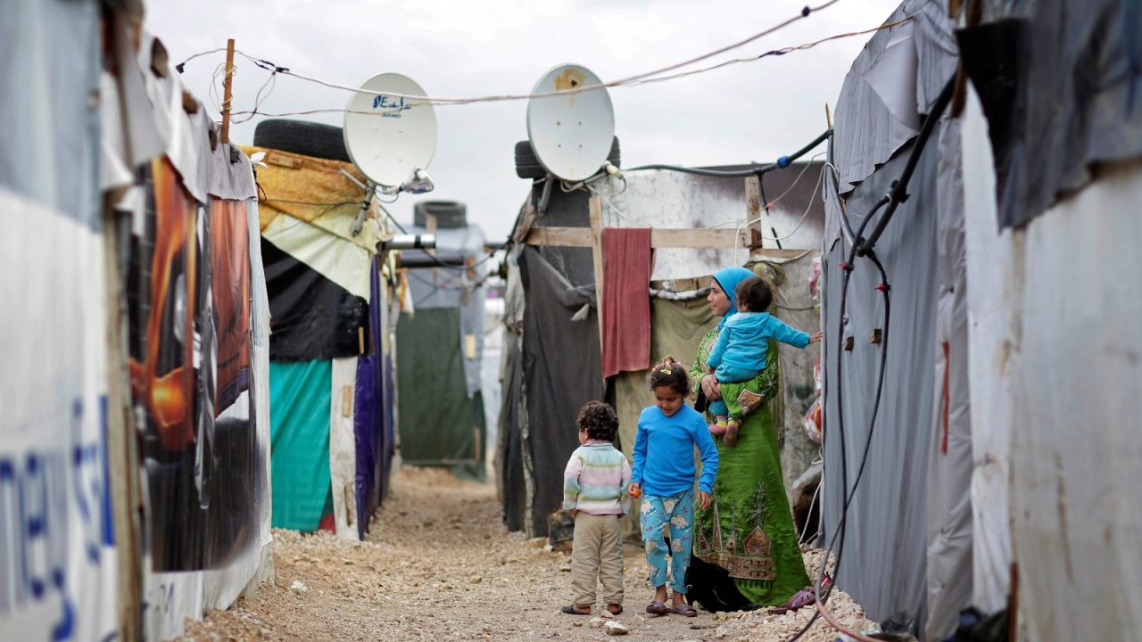 ZAHLE, LEBANON - DECEMBER 09: Woman with three children in an informal tented settlement of Syrian refugees on December 09, 2014 in Zahle, Lebanon. The ongoing civil war in Syria continues to force masses
of Syrians into neighboring Lebanon. (Photo by Thomas Koehler/Photothek via Getty Images)