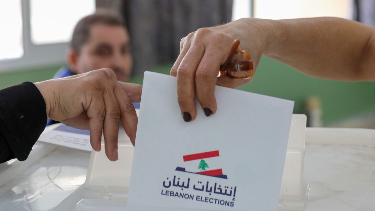 A Lebanese woman casts her ballot for the parliamentary election at a polling station in the Lebanese capital Beirut, on May 15, 2022. - Lebanon voted in its first election since multiple crises dragged it to the brink of failed statehood, with the ruling elite expected to comfortably weather public anger. The parliamentary election is a first test for opposition movements spawned by an unprecedented anti-establishment uprising in 2019 that briefly raised hopes of regime change in Lebanon. (Photo by IBRAHIM AMRO / AFP) / The erroneous mention[s] appearing in the metadata of this photo by IBRAHIM AMRO has been modified in AFP systems in the following manner: [Lebanese woman] instead of [a Shiite cleric]. Please immediately remove the erroneous mention[s] from all your online services and delete it (them) from your servers. If you have been authorized by AFP to distribute it (them) to third parties, please ensure that the same actions are carried out by them. Failure to promptly comply with these instructions will entail liability on your part for any continued or post notification usage. Therefore we thank you very much for all your attention and prompt action. We are sorry for the inconvenience this notification may cause and remain at your disposal for any further information you may require.