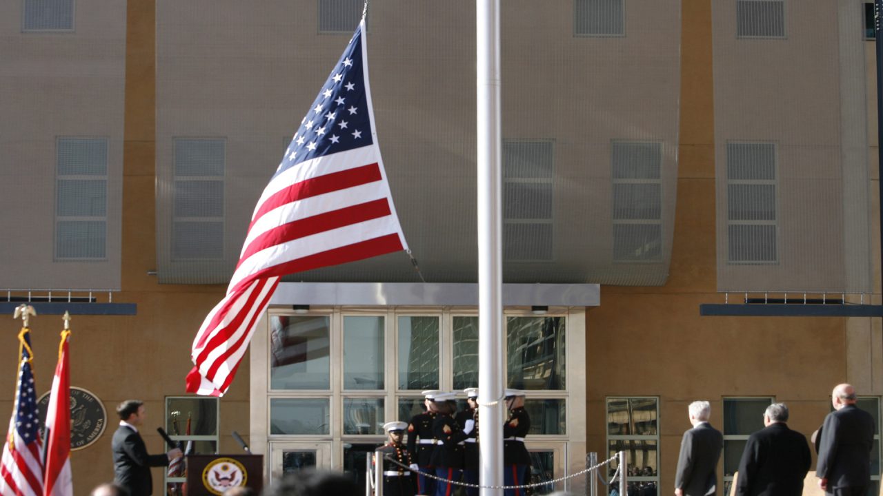 BAGHDAD, IRAQ - JANUARY 5:  The US flag is raised during a formal dedication ceremony attended by the Iraqi President Jalal Talabani, at the new US embassy amid heavy security, in Green Zone, on January 5, 2009 in Baghdad, Iraq. The embassy compound is the biggest and most expensive that the US have built and will house 4000 staff.  (Photo by Getty Images)
