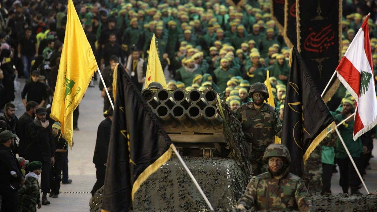 Members of Lebanon's militant Shiite Muslim movement Hezbollah stand on a pick-up truck mounted with a multiple rocket launcher as they take part in a parade in the southern city of Nabatiyeh on November 7, 2014, to mark the 13th day of Ashura, where believers mourn the killing of the Prophet Mohammed's grandson, Imam Hussein, during the battle of Karbala in central Iraq in the seventh century. AFP PHOTO / MAHMOUD ZAYYAT        (Photo credit should read MAHMOUD ZAYYAT/AFP/Getty Images)