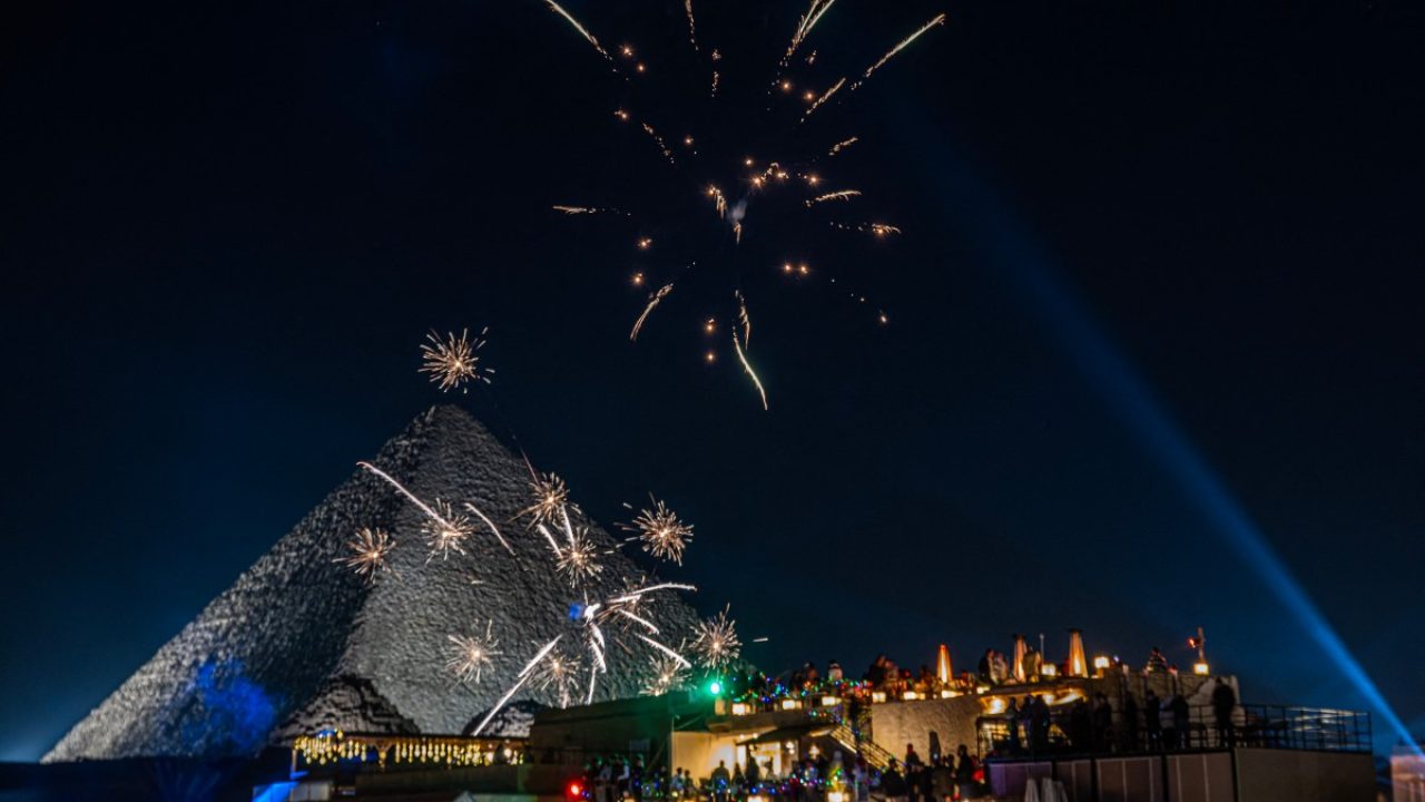 Fireworks explode above the Great Pyramids New Year's celebrations in Cairo on December 31, 2024. (Photo by Khaled DESOUKI / AFP)