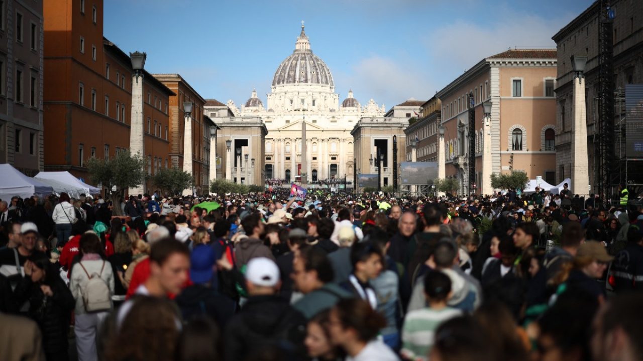 People gather along Via della Conciliazione street ahead of late Pope Francis' funeral ceremony, near the Vatican in Rome on April 26, 2025. Pope Francis, champion of the poor and the Church's first Latin American leader, will be honoured April 26 with a funeral attended by world leaders and tens of thousands of Catholic faithful. The Argentine pontiff, who died on April 21, 2025, aged 88, sought to create a more open-minded Church during his 12-year papacy, and many emotional tributes have been made -- with 250,000 people paying respects at his coffin in St Peter's Basilica. (Photo by HENRY NICHOLLS / AFP)