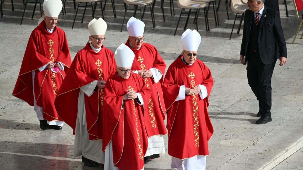 Cardinals walk to take their places ahead of the late Pope Francis' funeral ceremony at St Peter's Square at The Vatican on April 26, 2025. (Photo by Mandel NGAN / AFP)