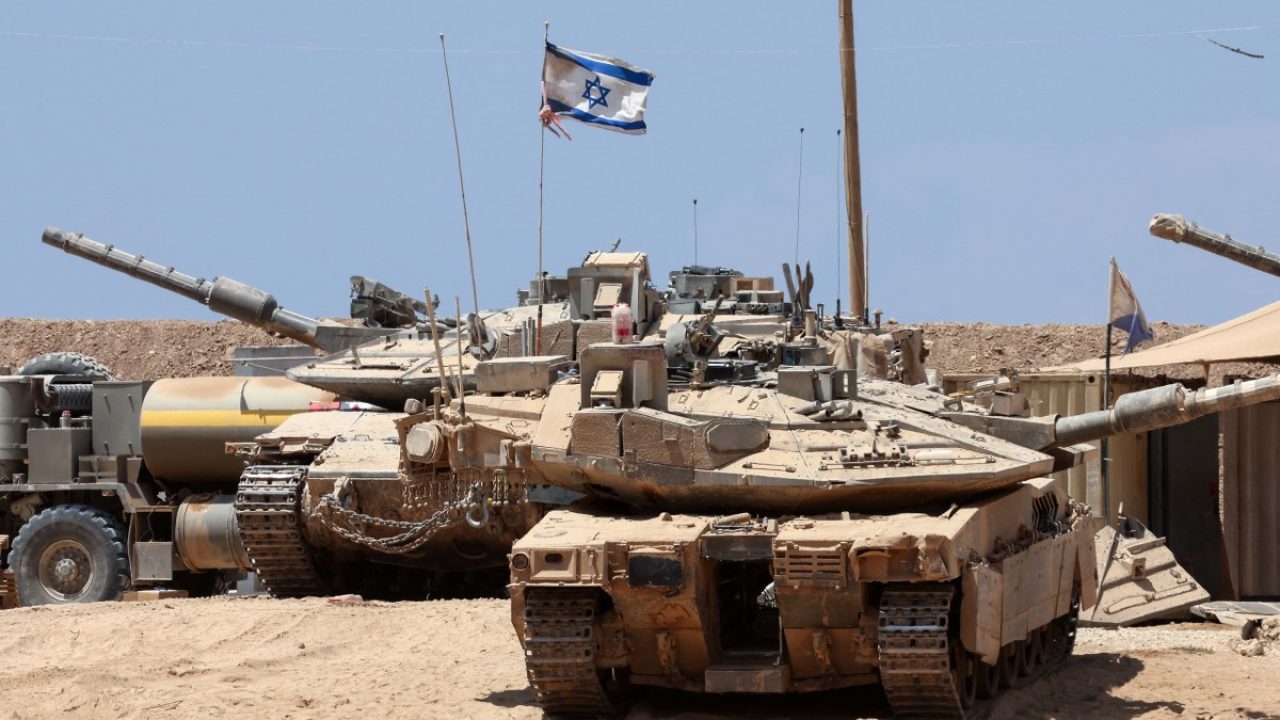 Israeli troops deploy with their tanks near the border fence with the Gaza Strip on August 1, 2025. (Photo by Jack GUEZ / AFP)