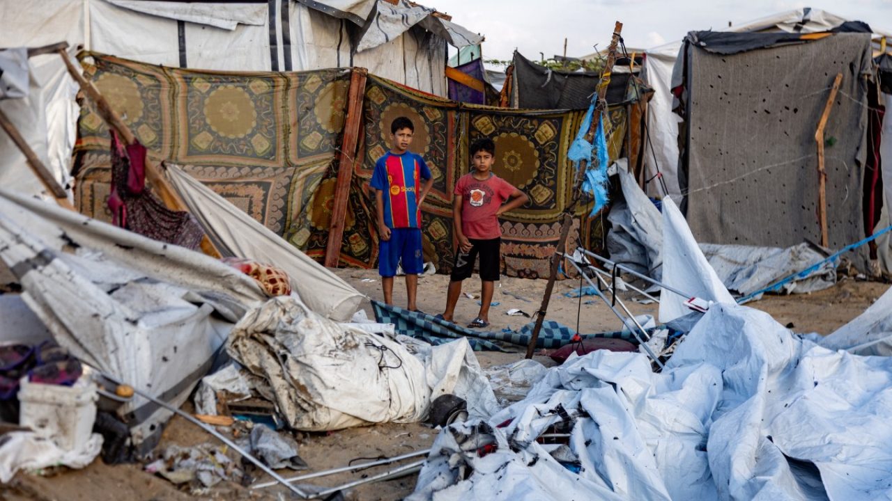 Children inspect the scene in the aftermath of overnight Israeli bombardment on a camp sheltering displaced people in the Mawasi area of Khan Yunis in the southern Gaza Strip on August 5, 2025. According to figures from Hams-run Gaza's health ministry, more than 60,933 Palestinians have been killed in the Palestinian territory after the Israeli army has devastated large parts of it in 22 months of combat sparked by the October 7, 2023 cross-border attacks by Hamas that killed 1,219 people and saw hundreds kidnapped. (Photo by AFP)