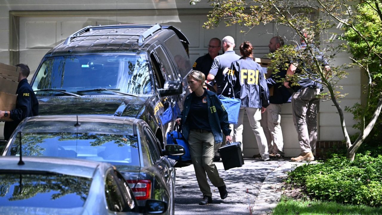 FBI agents remove items from Donald Trump's former national security advisor John Bolton's house, as the FBI conducted a court-authorized search at his place on August 22, 2025 in Bethesda, Maryland. Federal Bureau of Investigation agents searched on Friday the home and office of John Bolton, Donald Trump's former national security advisor, who has become a vocal critic of the US president. (Photo by SAUL LOEB / AFP)