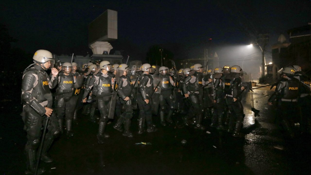 Police take a position to block protesters during a demonstration against higher lawmakers allowances and calling for the ratification of an asset confiscation bill in Gorontalo, Sulawesi, on September 1, 2025. Thousands rallied across Indonesia on September 1 as the military was deployed in the capital after six people were killed in nationwide protests sparked by anger over lavish perks for lawmakers. (Photo by Dhidot / AFP)