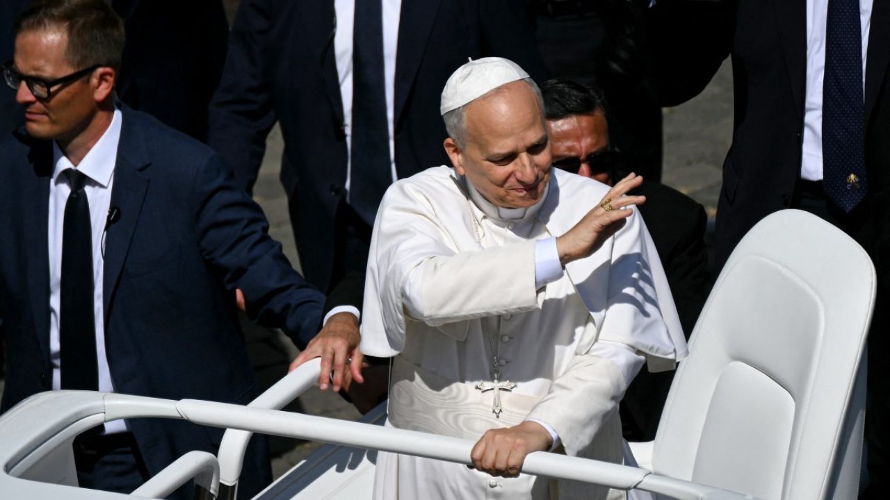 Pope Leo XIV greets faithful as he leaves in the Pope Mobile after presiding a Holy Mass and canonisation of Blessed Carlo Acutis and Pier Giorgio Frassati in St Peter's Square at the Vatican on September 7, 2025. An Italian teenager dubbed "God's Influencer" for his efforts to spread the Catholic faith online will become the first millennial saint Sunday at a canonisation attended by thousands of pilgrims. Computer whiz Carlo Acutis, who died of leukemia in 2006 aged 15, will be raised to sainthood by Pope Leo XIV in a solemn ceremony in St Peter's Square at the Vatican. Italian Pier Giorgio Frassati, a mountaineering enthusiast who died in 1925 and was known for his social and spiritual commitment, will also be made a saint on September 7, 2025. (Photo by Filippo MONTEFORTE / AFP)