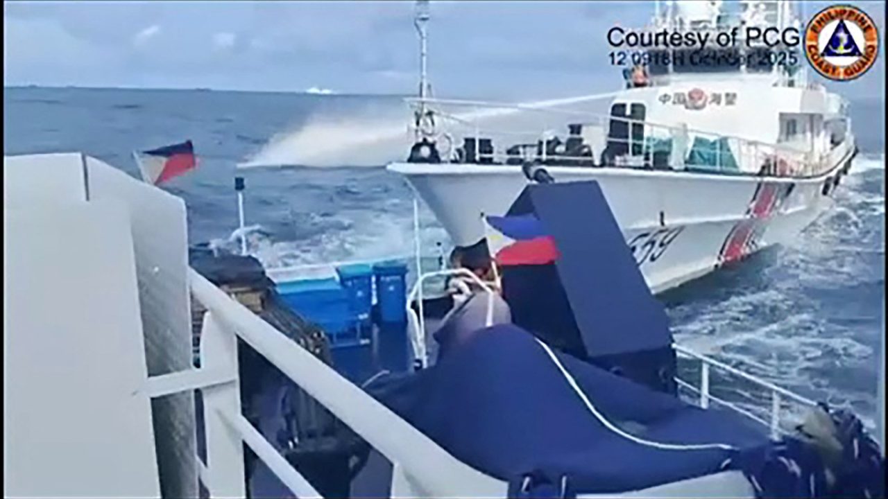 This frame grab from handout video footage taken and released on October 12, 2025 by the Philippine Coast Guard shows a China Coast Guard ship (R) deploying water cannon as seen from a Philippine Bureau of Fisheries vessel during an incident near Thitu island in disputed waters of the South China Sea. Manila's coast guard accused a Chinese ship of deliberately ramming a Philippine government vessel anchored near an island in the South China Sea on October 12, as China says the Philippines is "fully responsible" for the collision. (Photo by Handout / Philippine Coast Guard (PCG) / AFP) / RESTRICTED TO EDITORIAL USE - MANDATORY CREDIT "AFP PHOTO /  PHILIPPINE COAST GUARD" - HANDOUT - NO MARKETING NO ADVERTISING CAMPAIGNS - DISTRIBUTED AS A SERVICE TO CLIENTS
