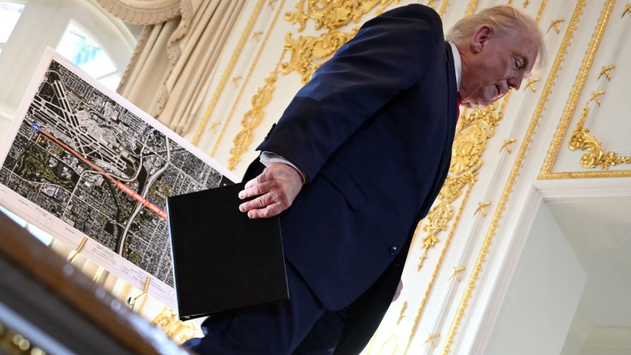 US President Donald Trump walks off the stage past a map, showing the portion of Palm Beach Southern Boulevard that is being renamed as "President Donald J. Trump Boulevard", during a dedication ceremony in the ballroom at Mar-a-Lago in Palm Beach, Florida, on January 16, 2026. (Photo by ANDREW CABALLERO-REYNOLDS / AFP)
