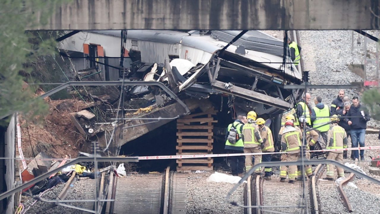 A picture taken on January 21, 2026 shows a regional service train the morning after it collided with a collapsed wall (L), killing one person and injuring seriously five, between Sant Sadurni d'Anoia and Gelida, near Barcelona. The latest incident is likely to raise more questions about Spanish rail safety after the collision of two high-speed trains in the southern region of Andalusia on Sunday killed 42 people and injured more than 120.  (Photo by Josep LAGO / AFP)