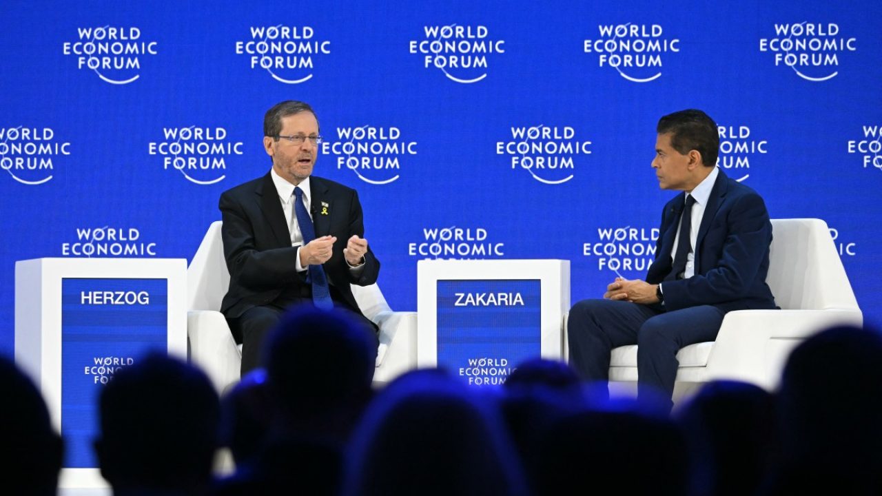 Israel's President Isaac Herzog (L) speaks with CNN Indian-American journalist Fareed Zakaria during the World Economic Forum (WEF) annual meeting in Davos on January 22, 2026. The World Economic Forum takes place in Davos from January 19 to January 23, 2026. (Photo by Fabrice COFFRINI / AFP)