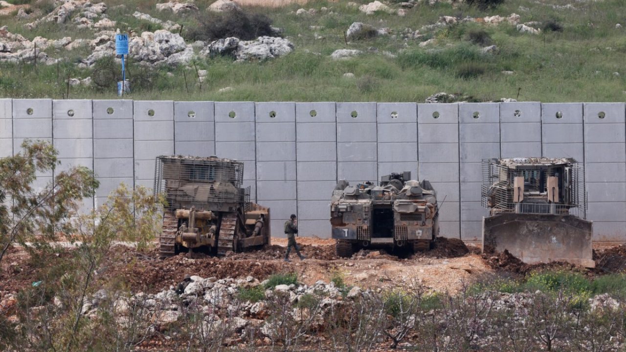 Israeli military vehicles are positioned along the Israel-Lebanon border, as seen from northern Israel, on April 12, 2026. Hezbollah and Israeli forces have been clashing since March 2, two days after the start of the Iran war, following rocket fire by the Lebanese armed group at Israel in retaliation for the killing of Iran's leader. (Photo by Jalaa MAREY / AFP) /