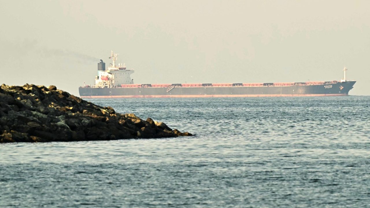 (FILES) A cargo ship is pictured off coast city of Fujairah, in the Strait of Hormuz in the northern Emirate on February 25, 2026. The US military said it would begin a blockade of all Iranian ports on April 13, 2026, after talks between the warring sides in Pakistan collapsed with the US President blaming Iran's refusal to abandon its nuclear ambitions. (Photo by Giuseppe CACACE / AFP)