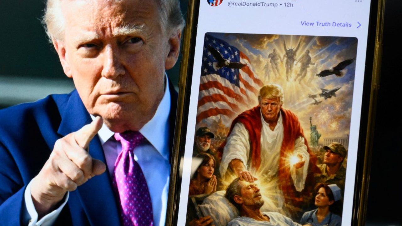 This photo illustration created on April 13, 2026 shows a picture of US President Donald Trump on a screen and an AI-generated picture he posted on his Truth Social platform depicting himself as Jesus Christ after criticizing Pope Leo XIV. Trump later posted an AI-generated image seemingly depicting himself as Jesus Christ. In the image, the president appears dressed in red and white robes as he cures a man with his healing hand. The American flag is shown over his shoulder. Trump and the White House have previously shared AI-generated images, including one that showed the president dressed as the pope. (Photo by Mandel NGAN / AFP)
