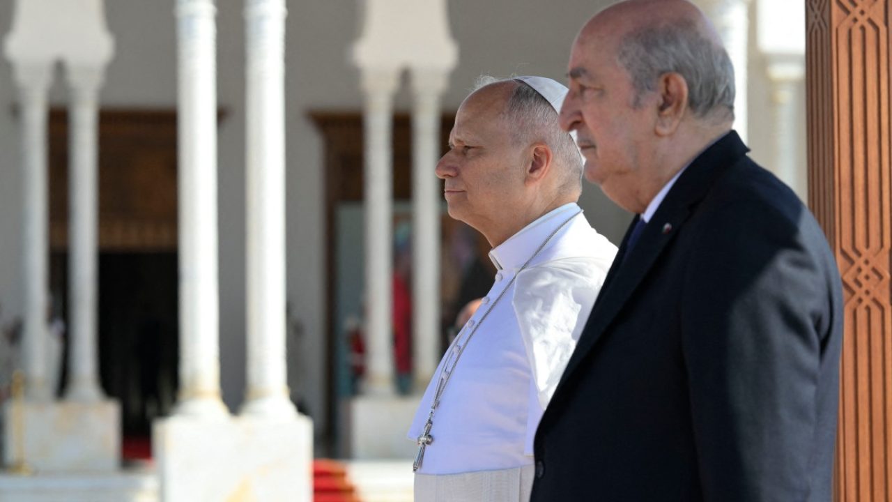 This handout picture taken and released by the Vatican Media shows Algeria's President Abdelmadjid Tebboune and Pope Leo XIV at the Houari Boumediene International Airport, before Pope Leo XIV departure to Yaounde, on April 15, 2026. (Photo by Handout / VATICAN MEDIA / AFP) / RESTRICTED TO EDITORIAL USE - MANDATORY CREDIT "AFP PHOTO / VATICAN MEDIA" - NO MARKETING NO ADVERTISING CAMPAIGNS - DISTRIBUTED AS A SERVICE TO CLIENTS