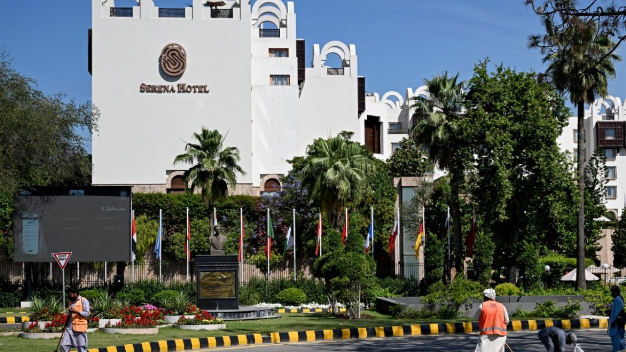Sanitation workers sweep a street in front of the Serena Hotel, that hosted the first round of US-Iran peace talks during the Middle East war, after authorities reopened the Red Zone area in Islamabad on April 26, 2026 following eased security measures and restrictions. Pakistan's Prime Minister Shehbaz Sharif said he had spoken to Iranian President Masoud Pezeshkian on April 25 after the second round of US-Iran negotiations in Islamabad were called off and reiterated Islamabad's commitment to facilitating "durable peace". (Photo by Aamir QURESHI / AFP)