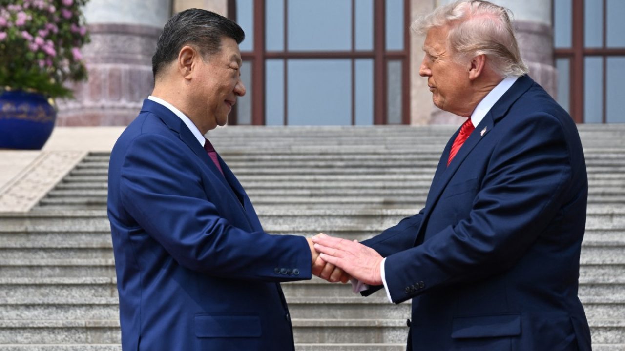 US President Donald Trump (R) shakes hands with China's President Xi Jinping at the Great Hall of the People in Beijing on May 14, 2026. (Photo by Kenny HOLSTON / POOL / AFP)