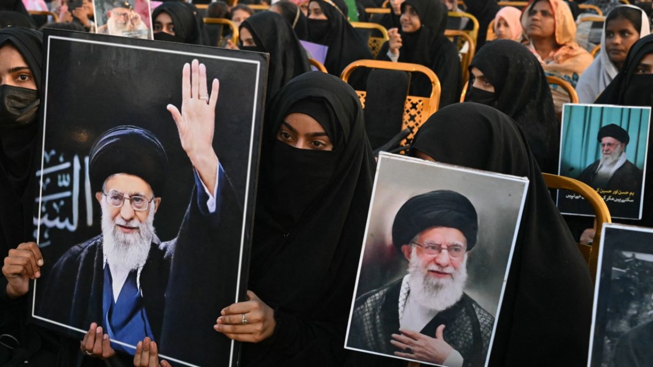 Activists carry portraits of Irans slain supreme leader Ayatollah Ali Khamenei, as they pay tribute at Minar-e-Pakistan in Lahore on June 13, 2026, during the Shaheed-e-Ummat conference. (Photo by Arif Ali / AFP)