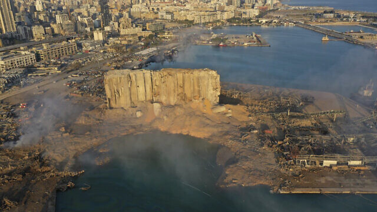 FILE - In this Aug. 5, 2020 file photo, smoke rises after an explosion the day before at the seaport of Beirut, Lebanon. On Thursday, Feb. 18, 2021, Lebanon's highest court asked the chief prosecutor investigating last year's massive Beirut port explosion to step down, following legal challenges by senior officials he had accused of negligence that led to the blast, a judicial official and the country's official news agency said. (AP Photo/Hussein Malla, File)