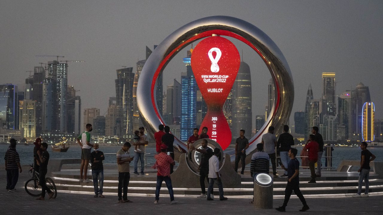 FILE - People gather around the official countdown clock showing remaining time until the kick-off of the World Cup 2022, in Doha, Qatar, Thursday, Nov. 25, 2021. FIFA has received 3 million ticket requests for the World Cup final in Qatar and high demand to attend some of its biggest group-stage games. The data revealed to The Associated Press by FIFA shows there have been 2.5 million ticket requests to see Argentina play Mexico on Nov. 26 at the 80,000-capacity Lusail Stadium and 1.4 million fans hope to see England face the United States the previous day at the 60,000-capacity Al Bayt Stadium. There have been more than two million ticket requests overall from the U.S., England and Qatar. (AP Photo/Darko Bandic, File)