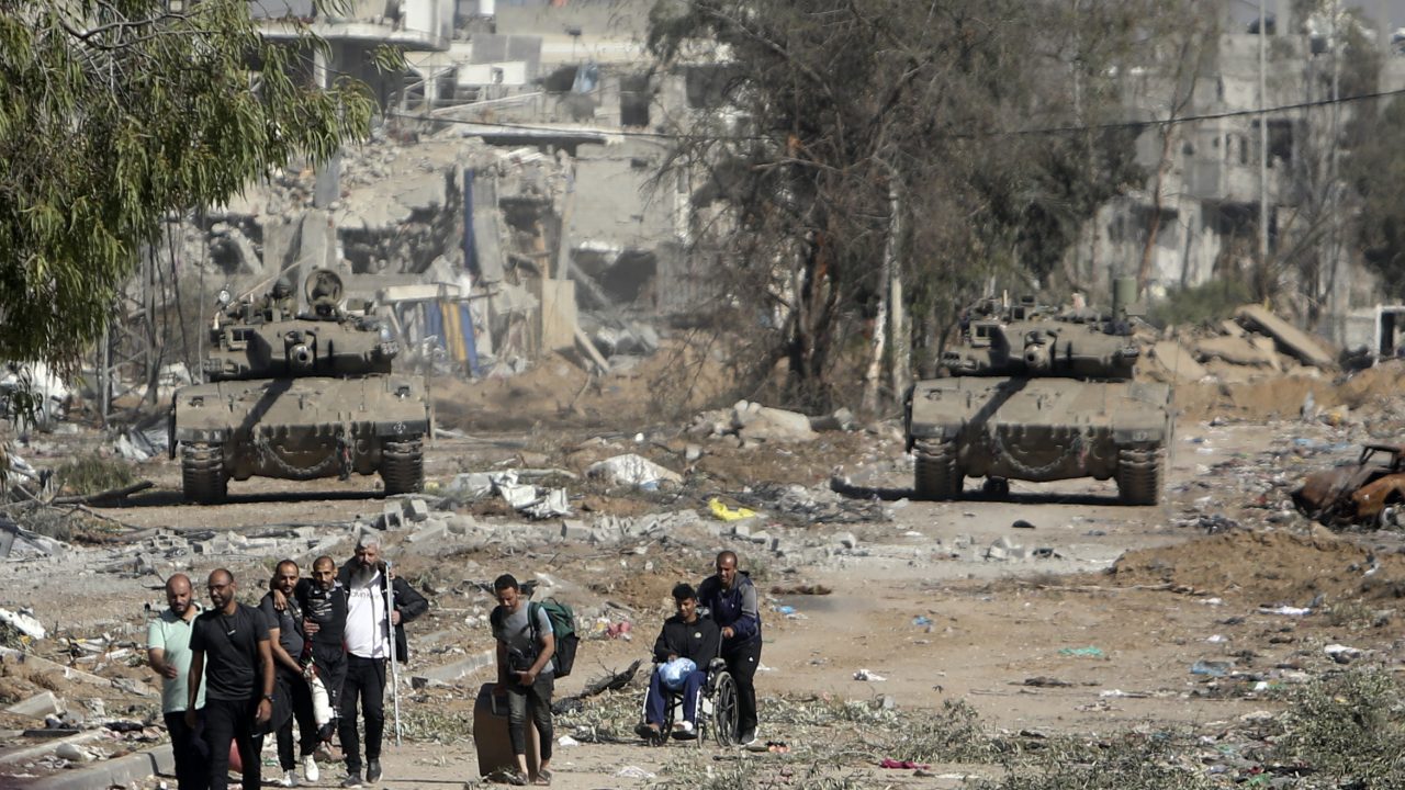 FILE - Palestinians flee to northern Gaza as Israeli tanks block the Salah al-Din road in the central Gaza Strip on Nov. 24, 2023, as the four-day cease-fire in the Israel-Hamas war begins as part of an agreement that Qatar helped broker. (AP Photo/Mohammed Dahman, File)