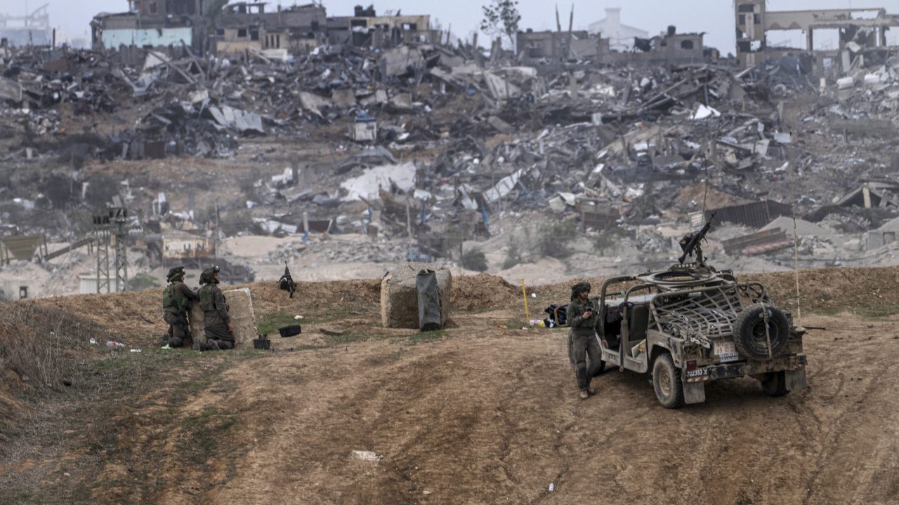 Israeli army vehicles and soldiers are seen near the Gaza Strip border, in southern Israel, Saturday, Dec. 23, 2023. The army is battling Palestinian militants across Gaza in the war ignited by Hamas' Oct. 7 attack into Israel. (AP Photo/Tsafrir Abayov)