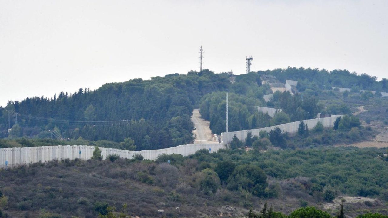 epa10913221 A view of the wall at the Israeli-Lebanon border, seen from Dhayra village, southern Lebanon, 11 October 2023. Hezbollah said on 11 October it fired missiles on Israel, two days after three of its members were killed in border towns. The Israel Defence Forces (IDF) said an anti-tank missile was launched from Lebanon toward a military post adjacent to the community of Arab Al-Aramshe on the BlueLine, and it responded by shelling Southern Lebanese towns.  EPA/WAEL HAMZEH