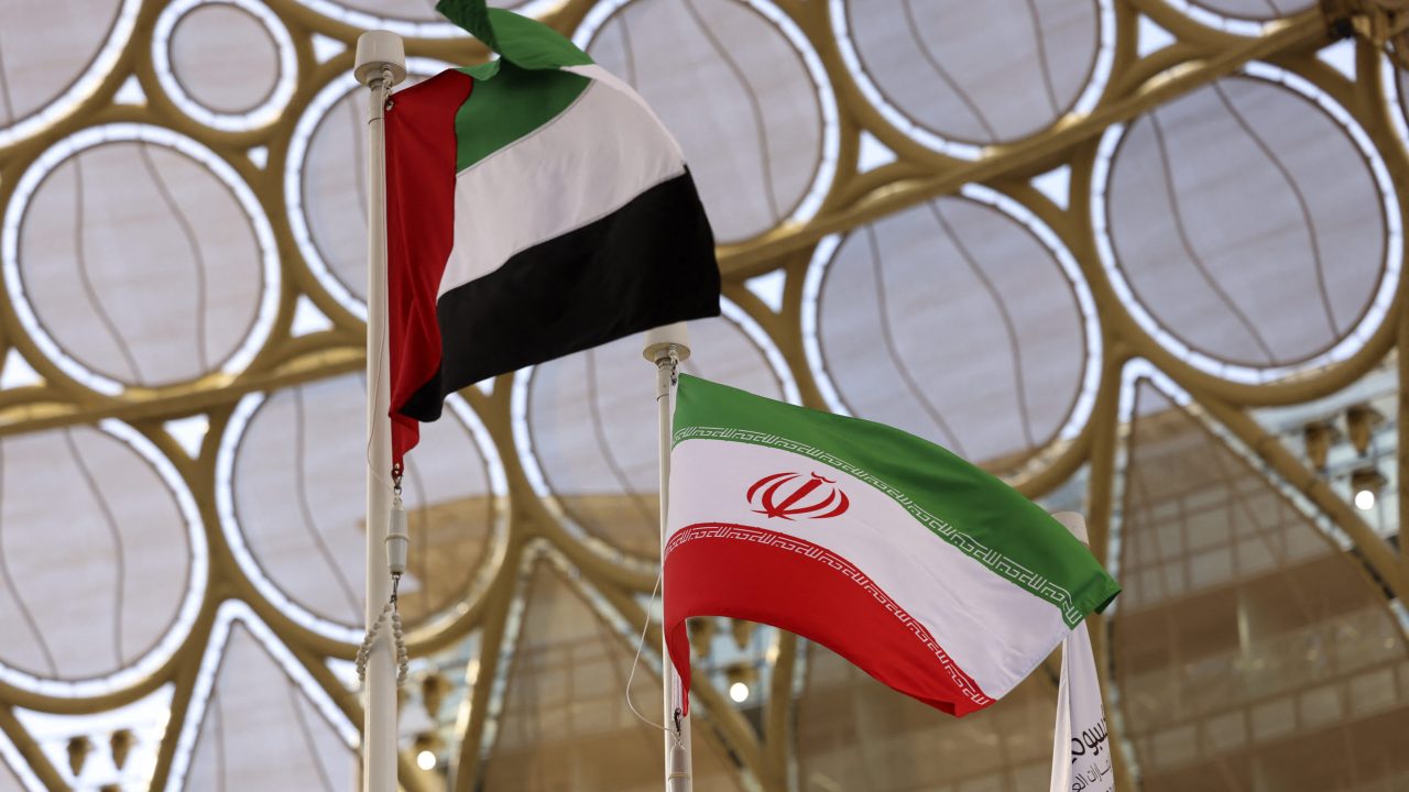 The flags of United Arab Emirates and Iran are pictured during a national event at the Iranian Pavilion of Expo 2020, in the Gulf emirate of Dubai on February 7, 2022. (Photo by Karim SAHIB / AFP)