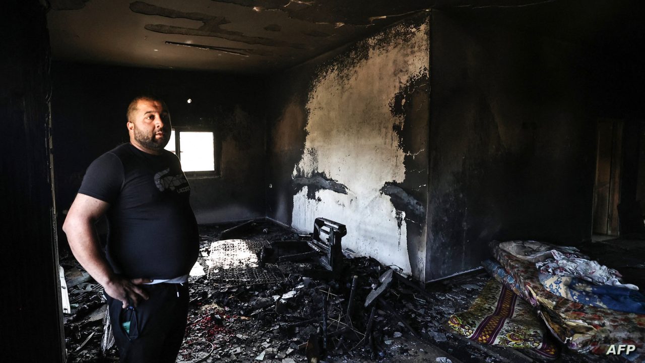 A Palestinian man stands amid the damage caused by fire, in the aftermath of an Israeli settler attack on the occupied West Bank village of Duma, on April 17, 2024. Hundreds of settlers came down through the fields surrounding Duma on April 13 and rampaged the village after the body of the 14-year-old Israeli herder Benjamin Achimeir who went missing on April 12 in the nearby illegal settler outpost of Malachi Hashalom was found. (Photo by Zain JAAFAR / AFP)